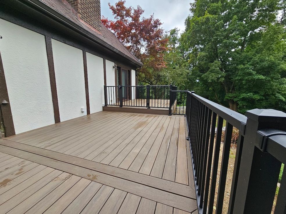 3 A large deck with black railing and white walls.
