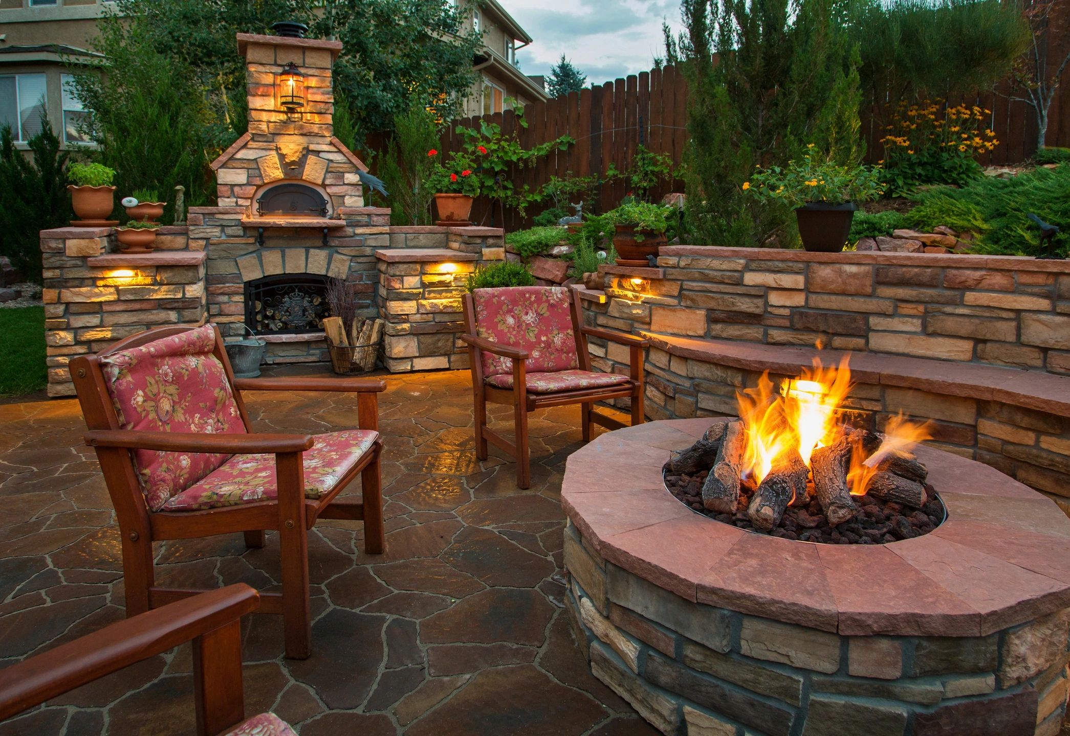 fm=f_532 A fire pit with chairs around it and lights on.